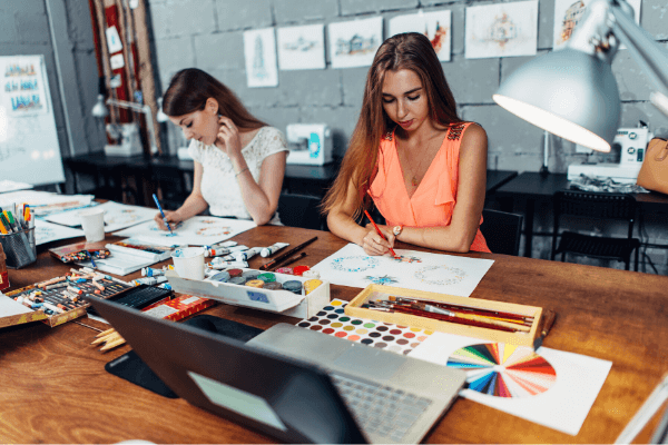 Artists testing art supplies at a table
